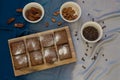 Chocolate brownies on a wooden board with chocolate chips, almonds, and pecans on a white bowl Royalty Free Stock Photo