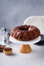 Chocolate bundt cake with chocolate ganache on top on a cake stand Royalty Free Stock Photo