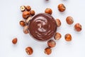 Chocolate butter and hazelnuts on a white acrylic background Royalty Free Stock Photo