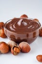 Chocolate butter and hazelnuts on a white acrylic background Royalty Free Stock Photo