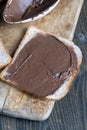 Chocolate butter spread on bread while cooking breakfast Royalty Free Stock Photo