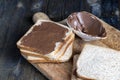 Chocolate butter spread on bread while cooking breakfast Royalty Free Stock Photo
