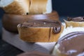 Chocolate butter spread on bread while cooking breakfast Royalty Free Stock Photo
