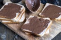 Chocolate butter spread on bread while cooking breakfast Royalty Free Stock Photo