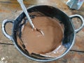 Chocolate cake batter in metal cauldron Royalty Free Stock Photo