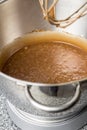 Chocolate cake batter in mixer bowl on kitchen table close up Royalty Free Stock Photo