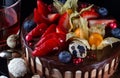 Chocolate cake with berries, strawberries, bog whortleberry and Chocolate Easter quai eggs