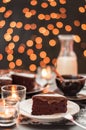Chocolate cake with blurry christmas lights. Royalty Free Stock Photo