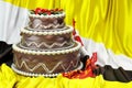 Chocolate cake on the Bruneian flag background, 3D rendering