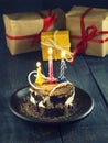 Chocolate cake with a candle and gifts.Happy Birthday, card. Holidays greeting card. Royalty Free Stock Photo