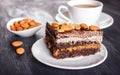 Chocolate cake with caramel, peanuts and almonds on a black wooden background Royalty Free Stock Photo