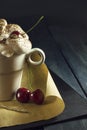 Chocolate cake with cherries and a cup of coffee with whipped cream. Coffee break. Royalty Free Stock Photo