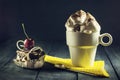 Chocolate cake with cherries and a cup of coffee with whipped cream. Royalty Free Stock Photo