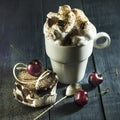 Chocolate cake with cherries and a cup of coffee with whipped cream. Royalty Free Stock Photo