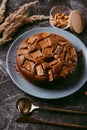 Chocolate cake with chocolate pieces on a metallic black background