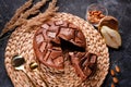 Chocolate cake with chocolate pieces on a metallic black background