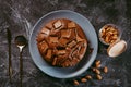 Chocolate cake with chocolate pieces on a metallic black background