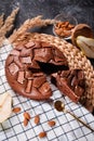 Chocolate cake with chocolate pieces on a metallic black background