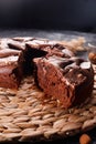 Chocolate cake with chocolate pieces on a metallic black background