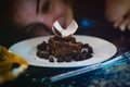 Chocolate cake close up with girl at the back Royalty Free Stock Photo