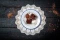 Chocolate cake with cream and fruit on retro wooden table