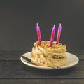 Chocolate cake with cream and three candles