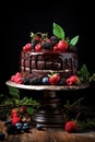 Chocolate cake decorated with strawberry, rapsberries and blackberry on top, dark wooden table background