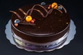 Chocolate cake with decoration and fruits as background Royalty Free Stock Photo