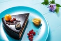 Chocolate cake with decoration and fruits on blue wooden background Royalty Free Stock Photo