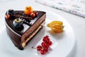 Chocolate cake with decoration and fruits on white wooden background Royalty Free Stock Photo