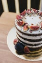 Chocolate cake with figs and nuts on a wooden table Royalty Free Stock Photo