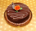 Chocolate cake on golden stars background Royalty Free Stock Photo