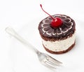 Chocolate cake icing with cherry on the plate isolated on a whit