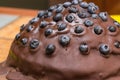 Chocolate cake made of chocolate pancakes with glaze, with blueberries. Vintage style. Royalty Free Stock Photo