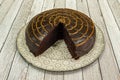 Chocolate cake with marked portions on a gray screen-printed plate