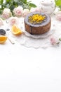Chocolate cake with orange and icing. On a white background, and a bouquet of white roses. Good morning with a surprise and Royalty Free Stock Photo