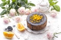 Chocolate cake with orange and icing. On a white background, and a bouquet of white roses. Good morning with a surprise and Royalty Free Stock Photo