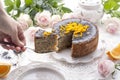 Chocolate cake with orange and icing. On a white background, and a bouquet of white roses. Good morning with a surprise and Royalty Free Stock Photo