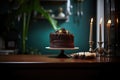 chocolate cake on pedestal with lit candles, dark ambiance Royalty Free Stock Photo