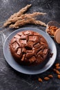 Chocolate cake with chocolate pieces on a metallic black background