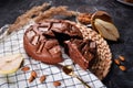 Chocolate cake with chocolate pieces on a metallic black background