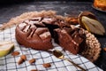 Chocolate cake with chocolate pieces on a metallic black background