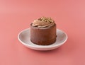 chocolate cake on a pink saucer on a pink background