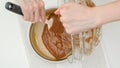 Chocolate cake recipe. Pouring cake batter into a baking pan Royalty Free Stock Photo