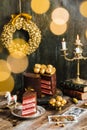 chocolate cake red velvet gold decoration rustic candles garland blur