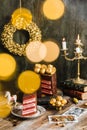 chocolate cake red velvet gold decoration rustic candles garland blur