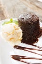 Chocolate cake with rum raisin ice cream and whipping cream on w Royalty Free Stock Photo