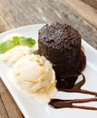 Chocolate cake with rum raisin ice cream and whipping cream on w Royalty Free Stock Photo