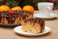 Chocolate cake and a slice of it on plate with cup of coffee Royalty Free Stock Photo