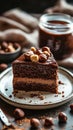 Chocolate cake slice topped with hazelnuts on a rustic plate with coffee and nuts in the background Royalty Free Stock Photo